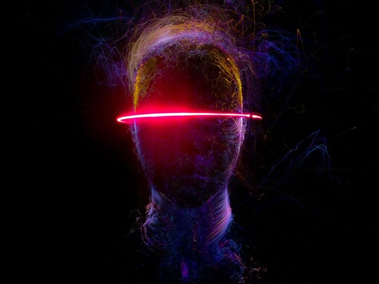 A creative portrait of a human head formed by vibrant neon light streaks.