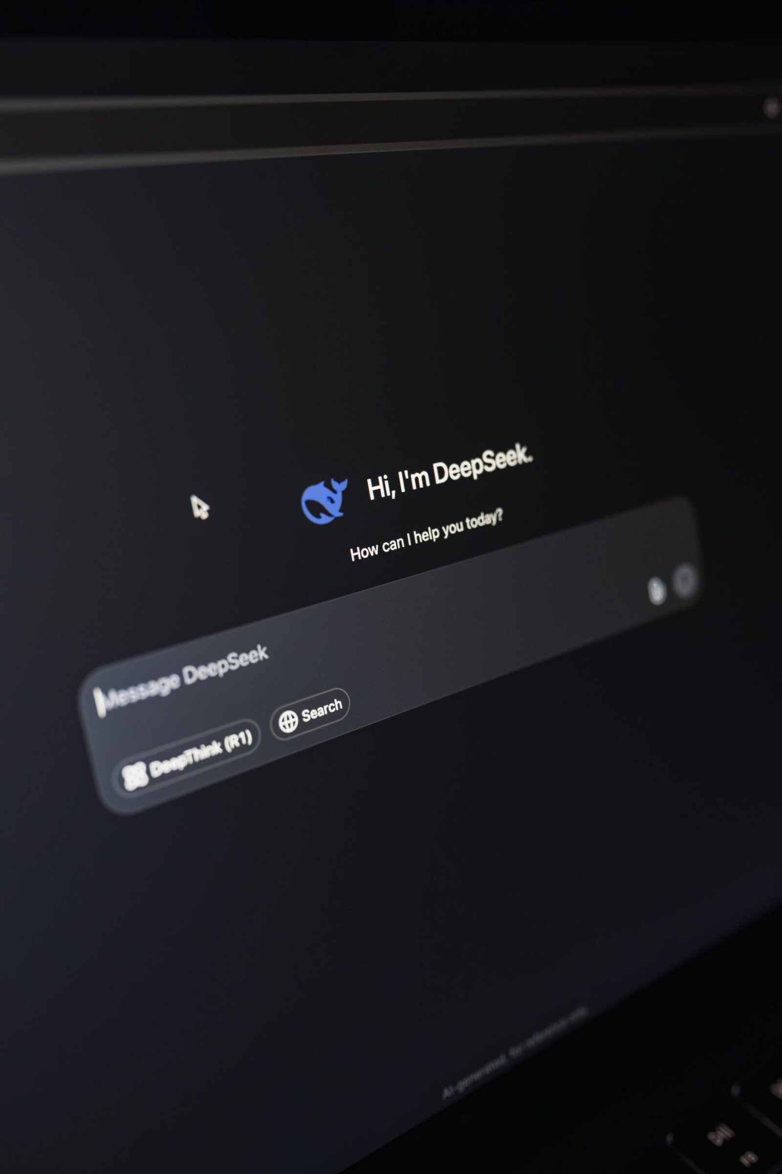 Close-up of a laptop displaying an AI chatbot interface in dark mode.