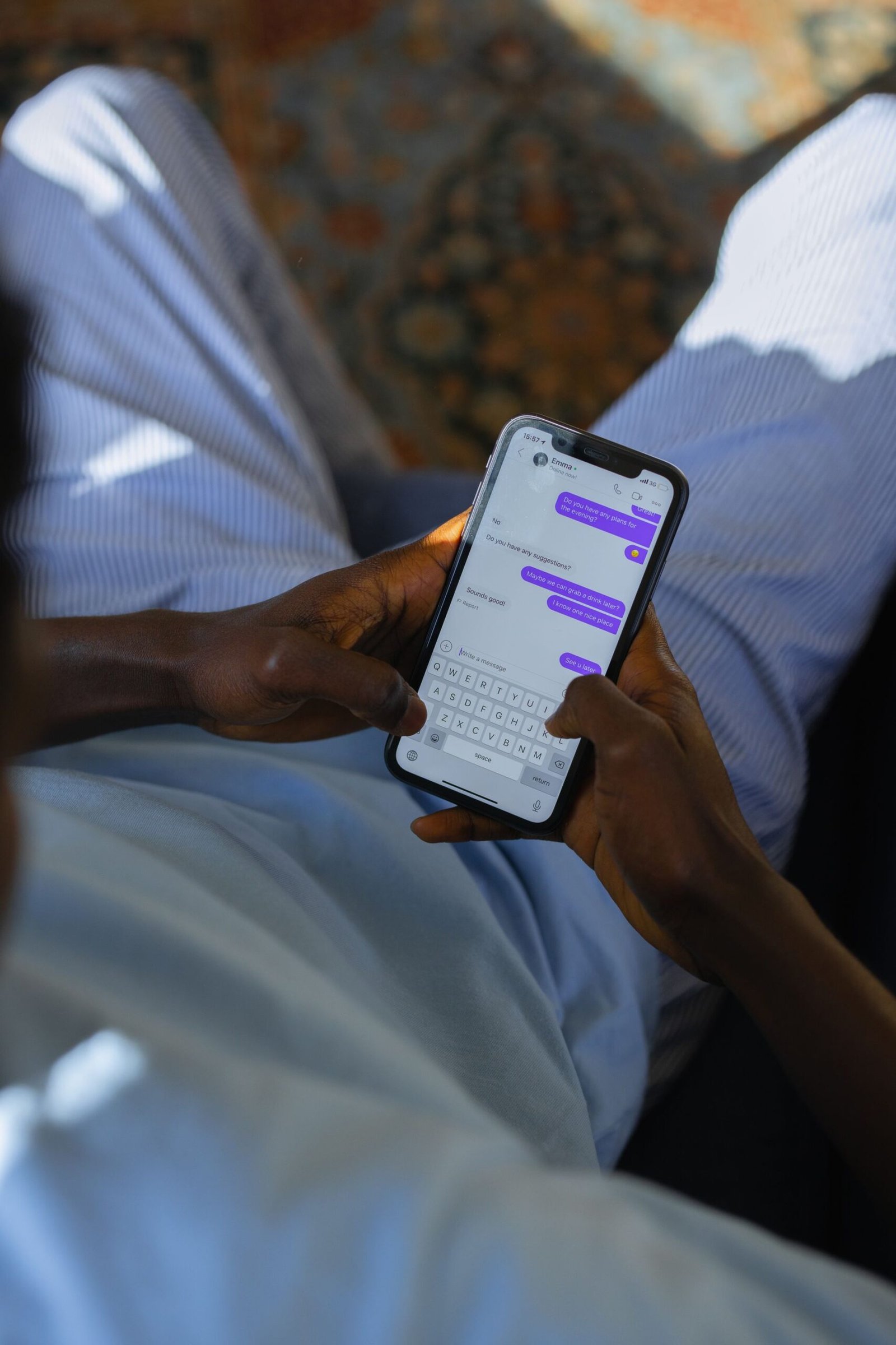Top view of a man typing a message on his smartphone.