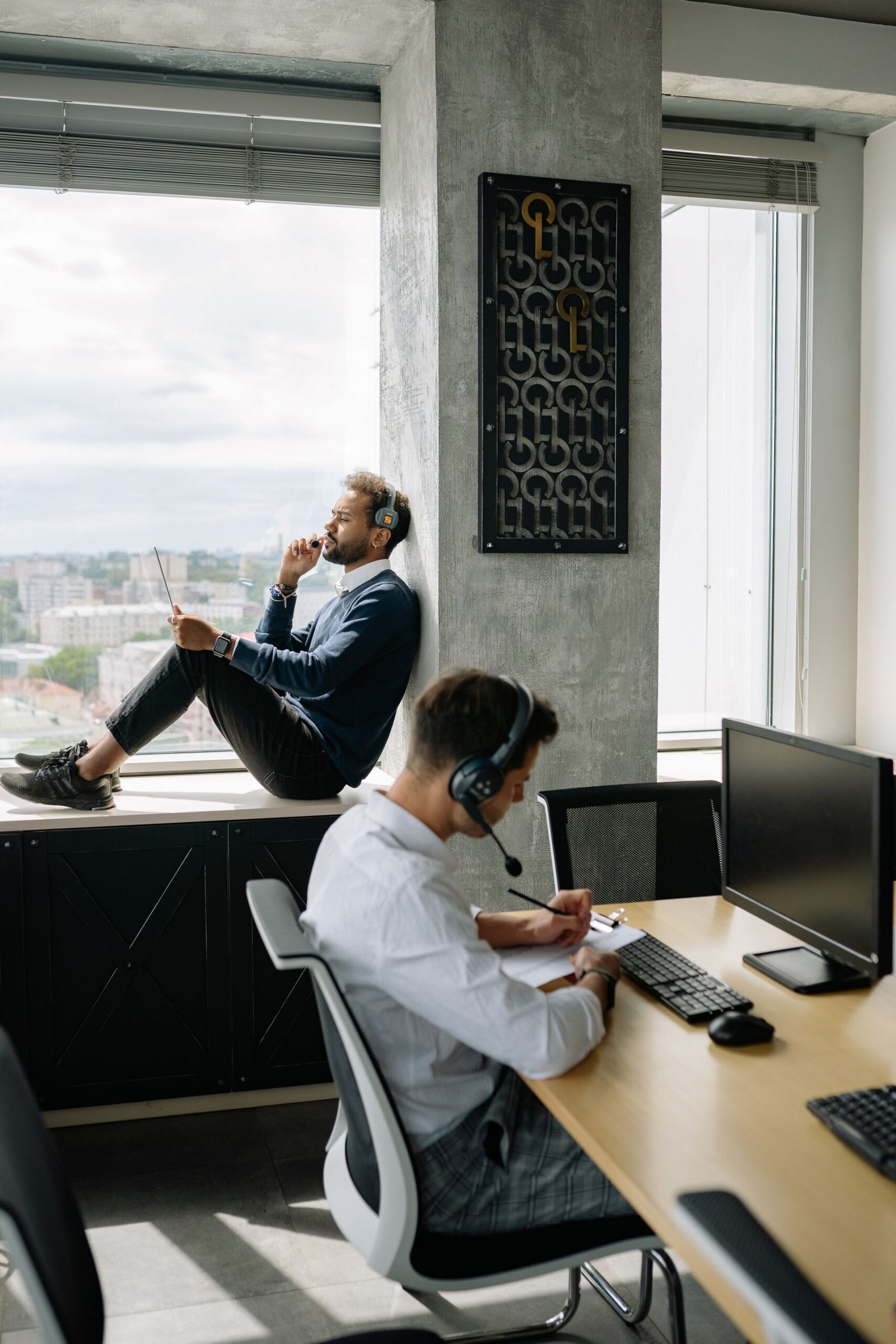 Two men working on computers in a modern office.