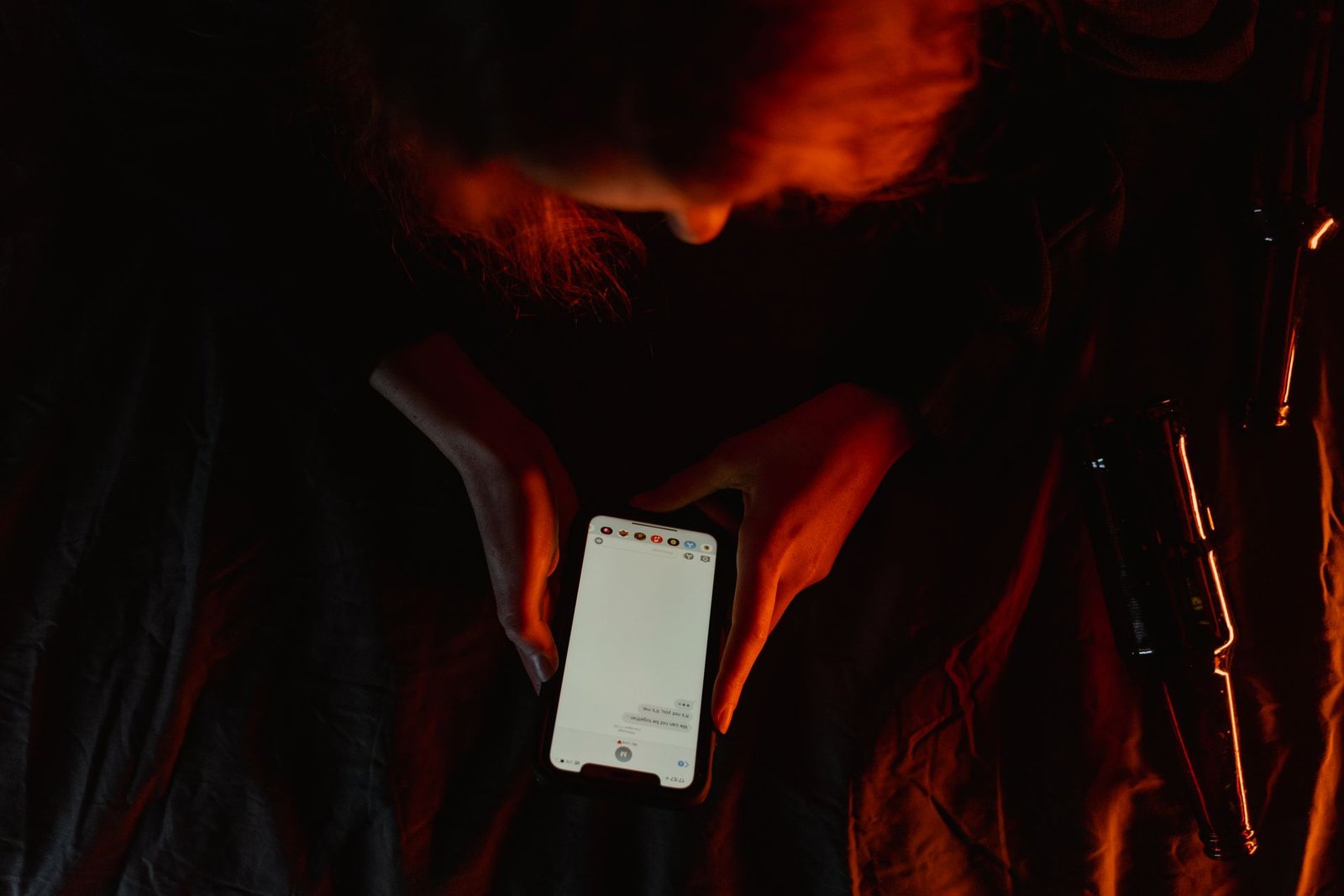 A smartphone charging on a desk next to everyday items.