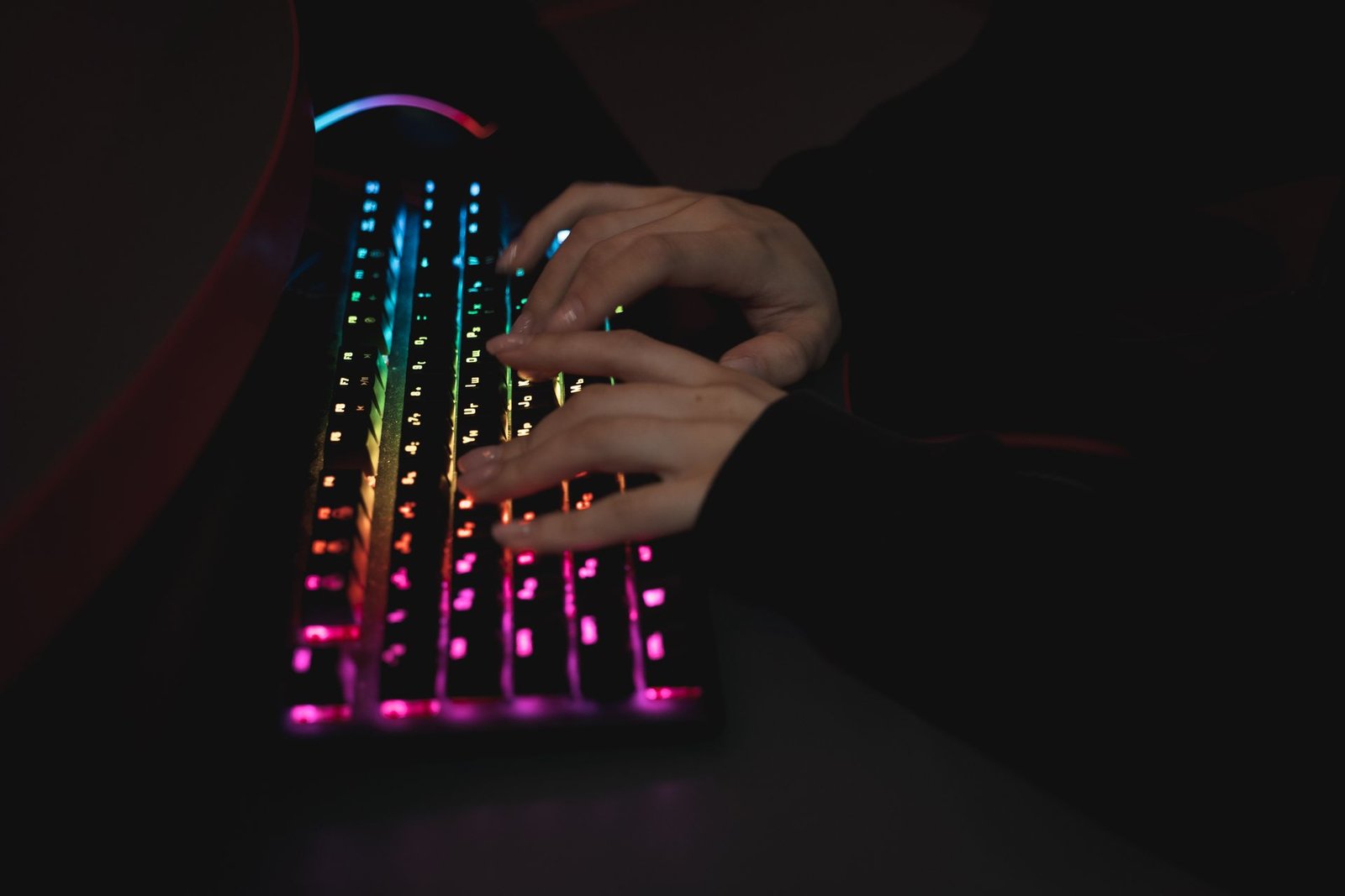 A person's hands typing on a mechanical keyboard at a desk.