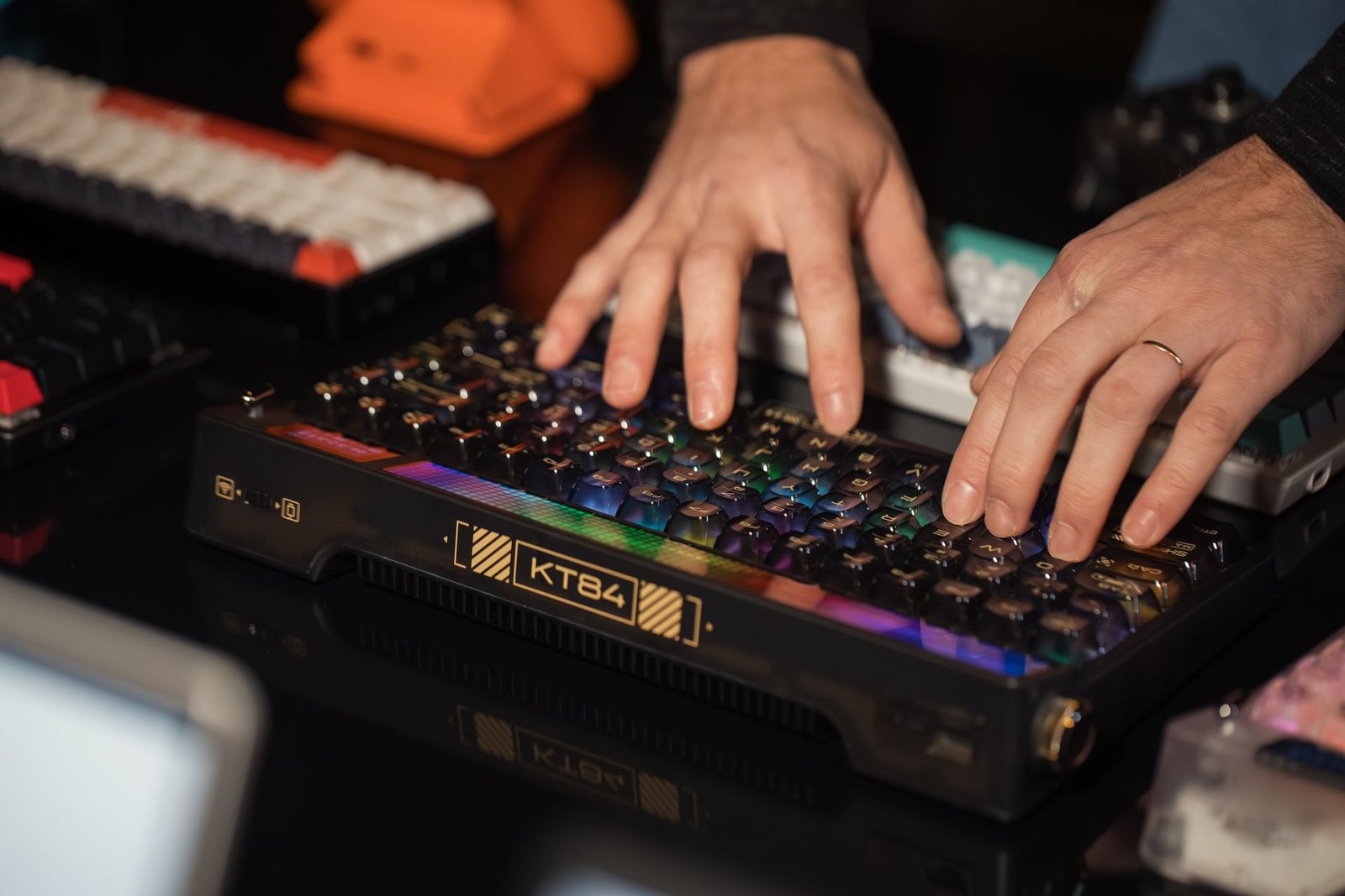 A mechanical keyboard with colorful backlighting on a desk setup.