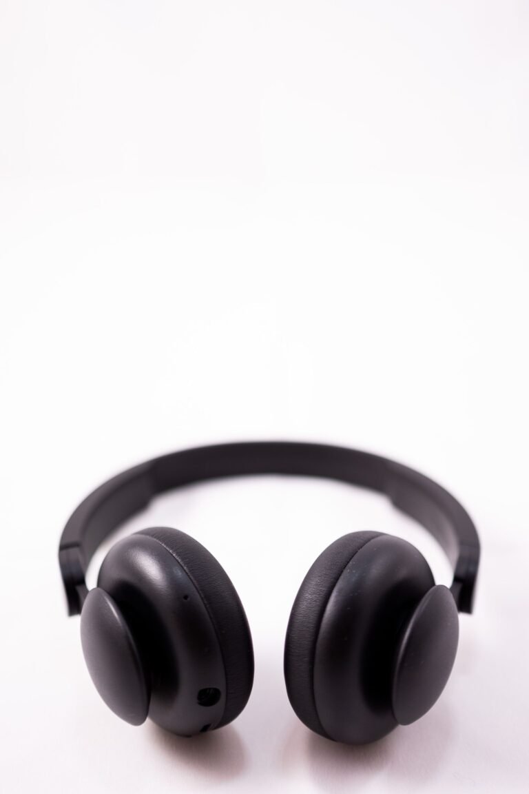 A pair of over-ear noise-cancelling headphones resting on a desk.