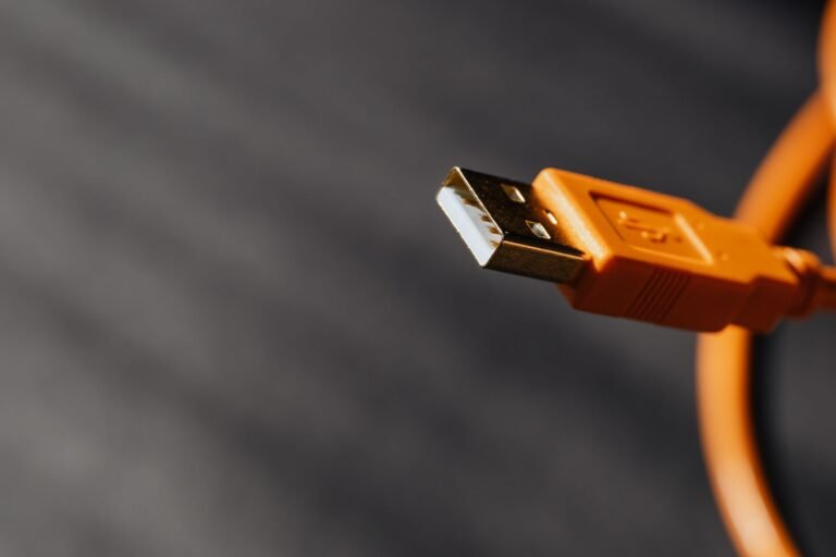 A close-up of a USB-C cable connector next to a laptop port.