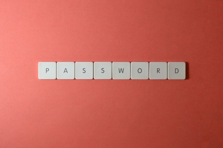 Keyboard tiles spelling out the word PASSWORD on a coral background.