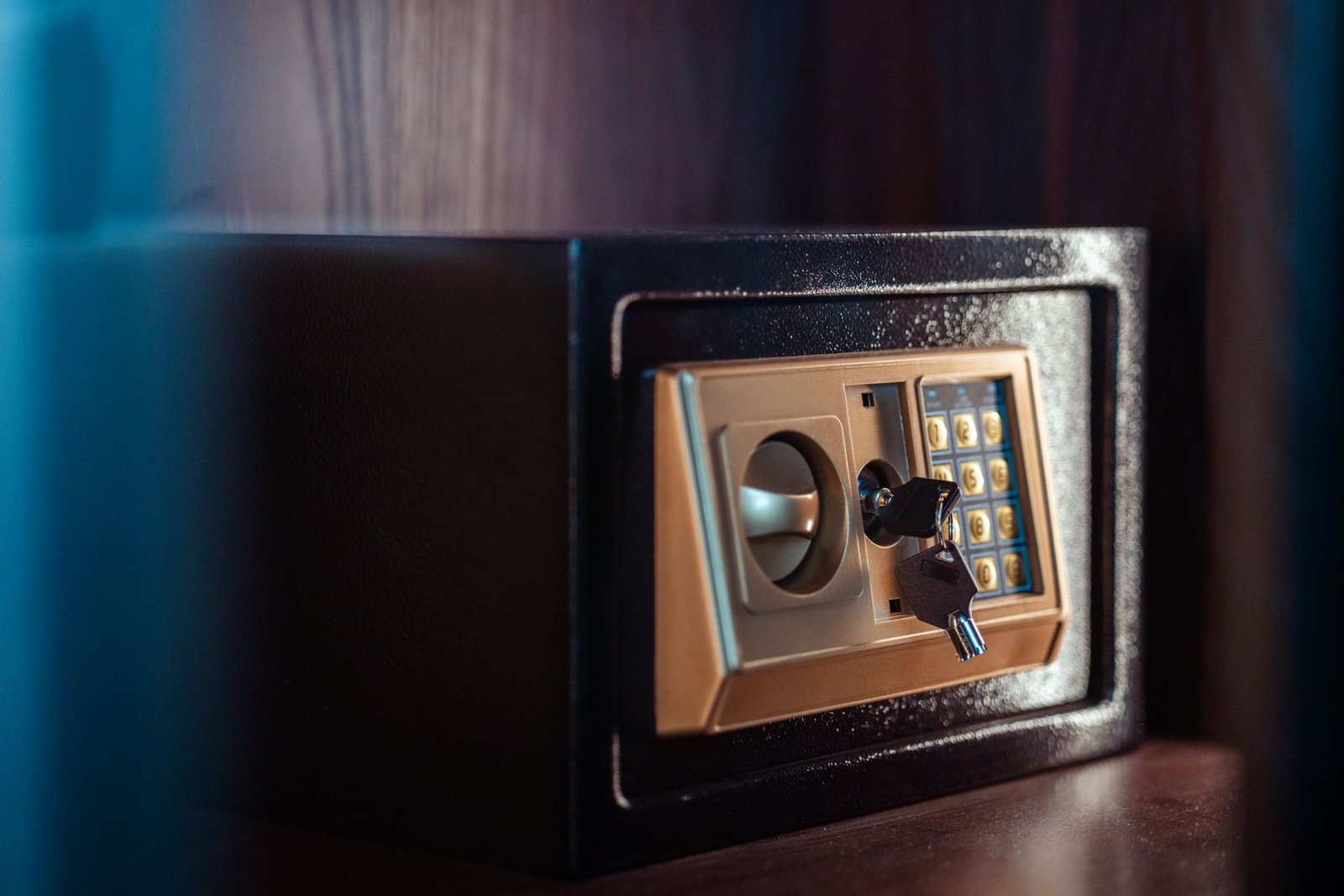 Close-up of an electronic safe with a key in the lock.
