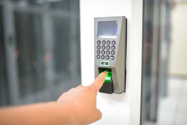 Person using a fingerprint scanner for secure entry.