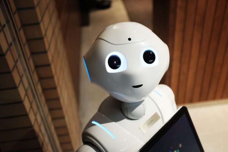 Close-up of a white humanoid robot's face, representing artificial intelligence systems that can hallucinate.
