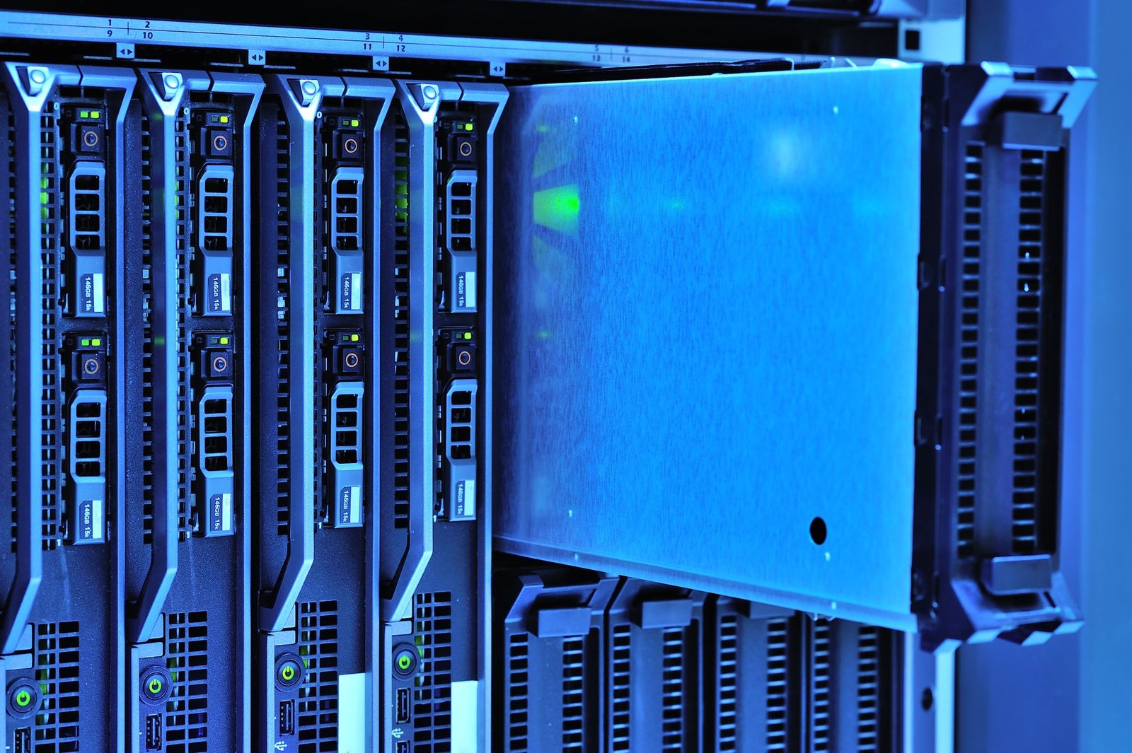A computer server rack inside a data center room with glowing indicator lights.