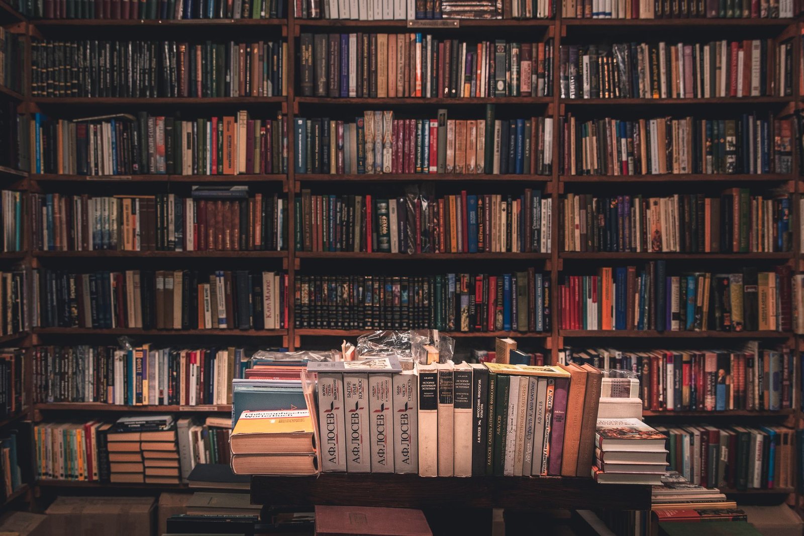 Tall wooden bookshelves filled with books in a grand library hall.