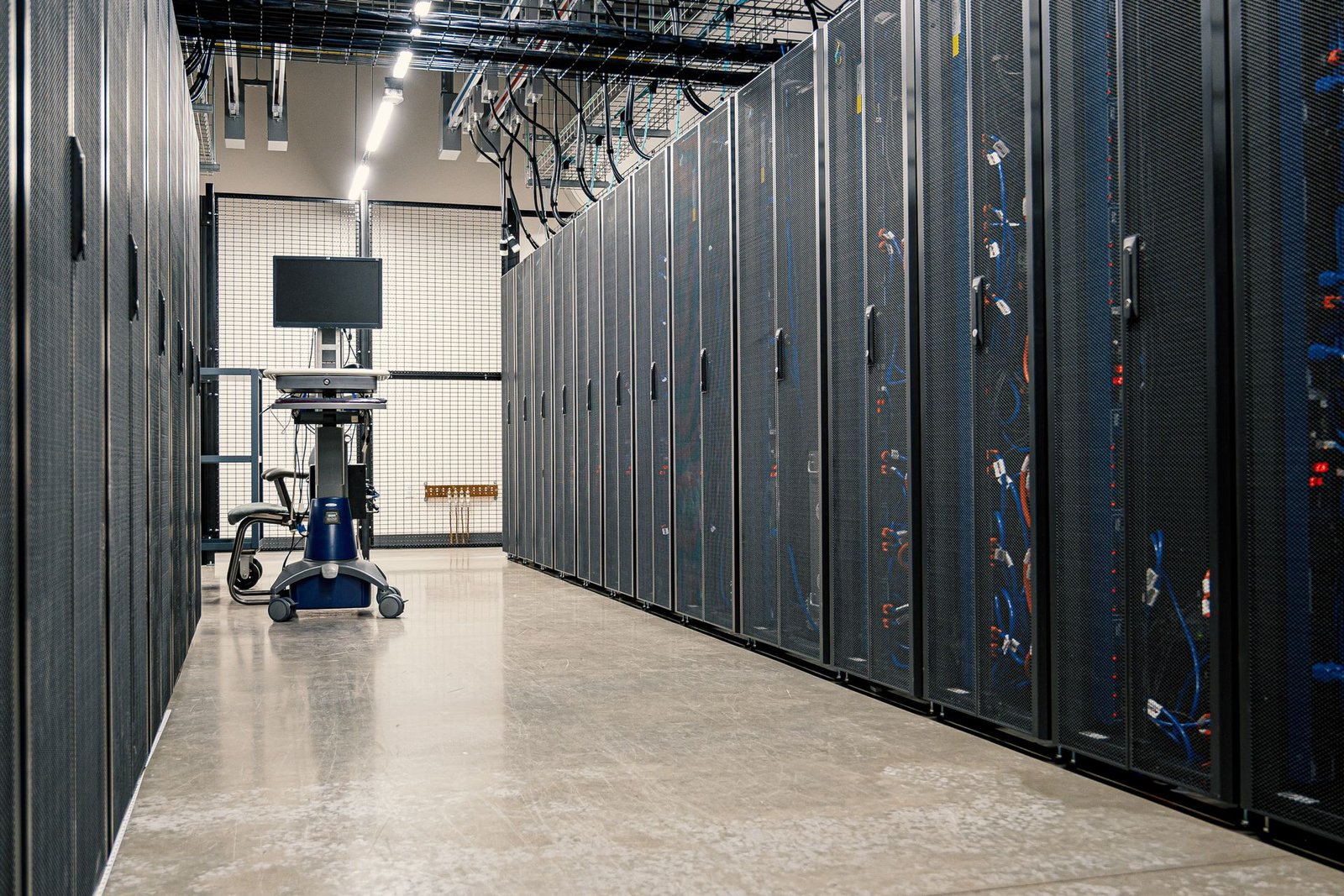 A corridor of server racks in a modern data center.