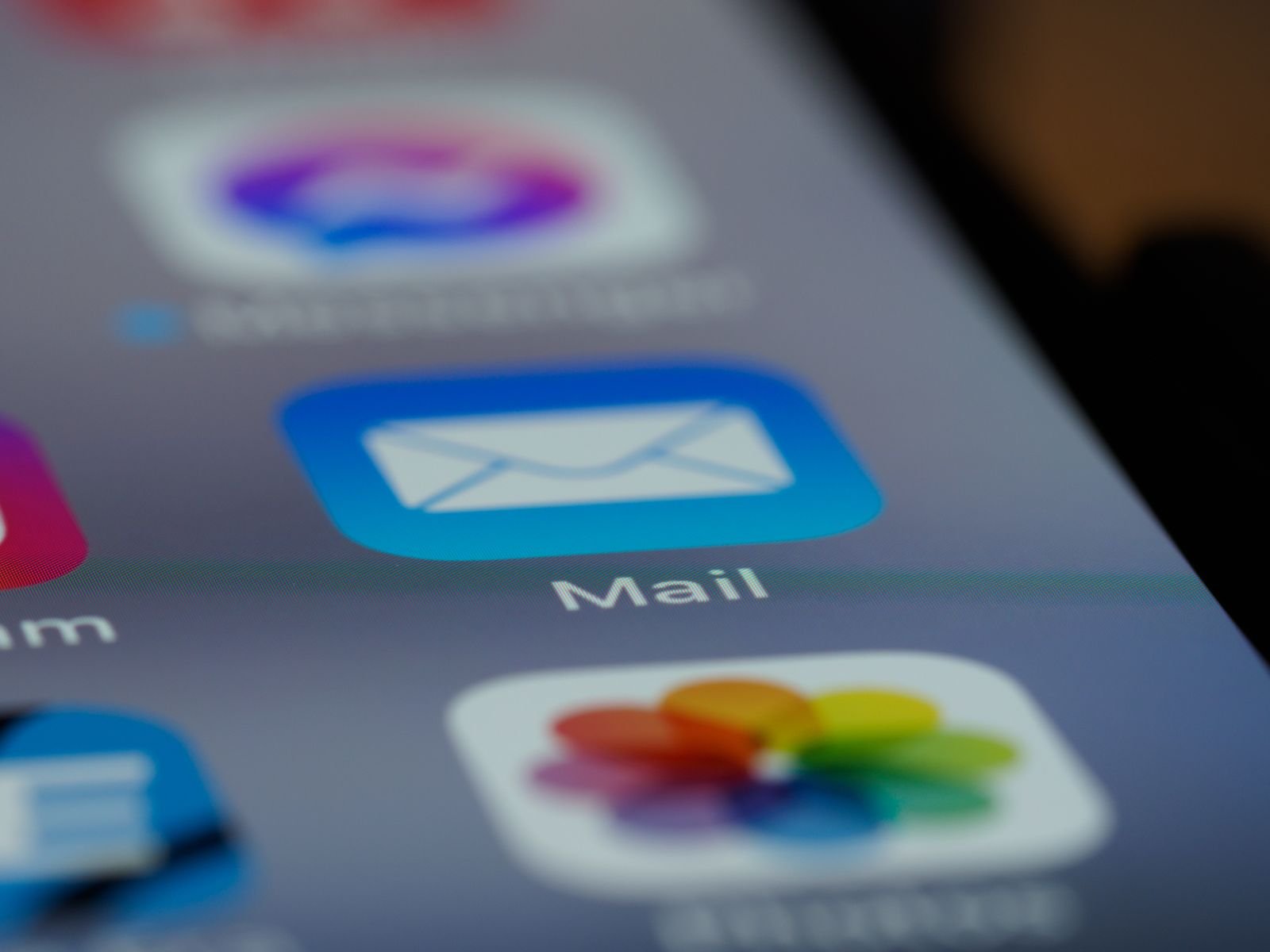 A close-up photo of a mail application icon on a smartphone screen.