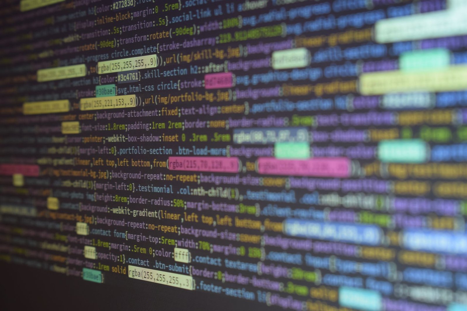 Close-up of colorful source code displayed on a computer monitor.