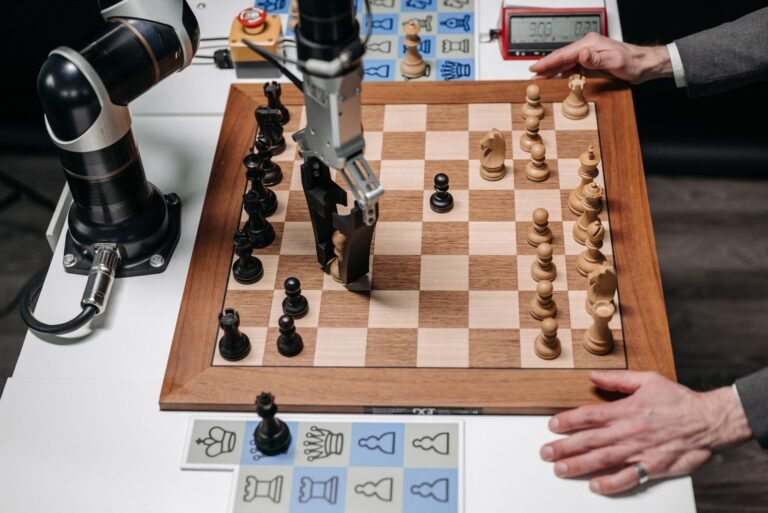 A robot arm picking up a chess piece during a game against a human player.
