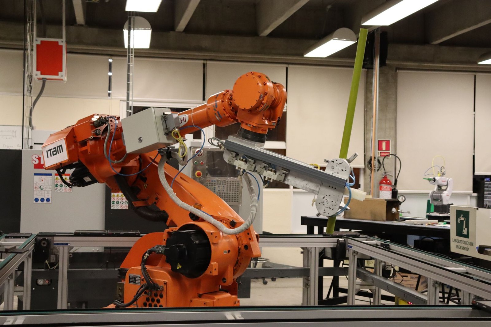 An industrial robotic arm in a modern laboratory, representing robots that learn through reinforcement.