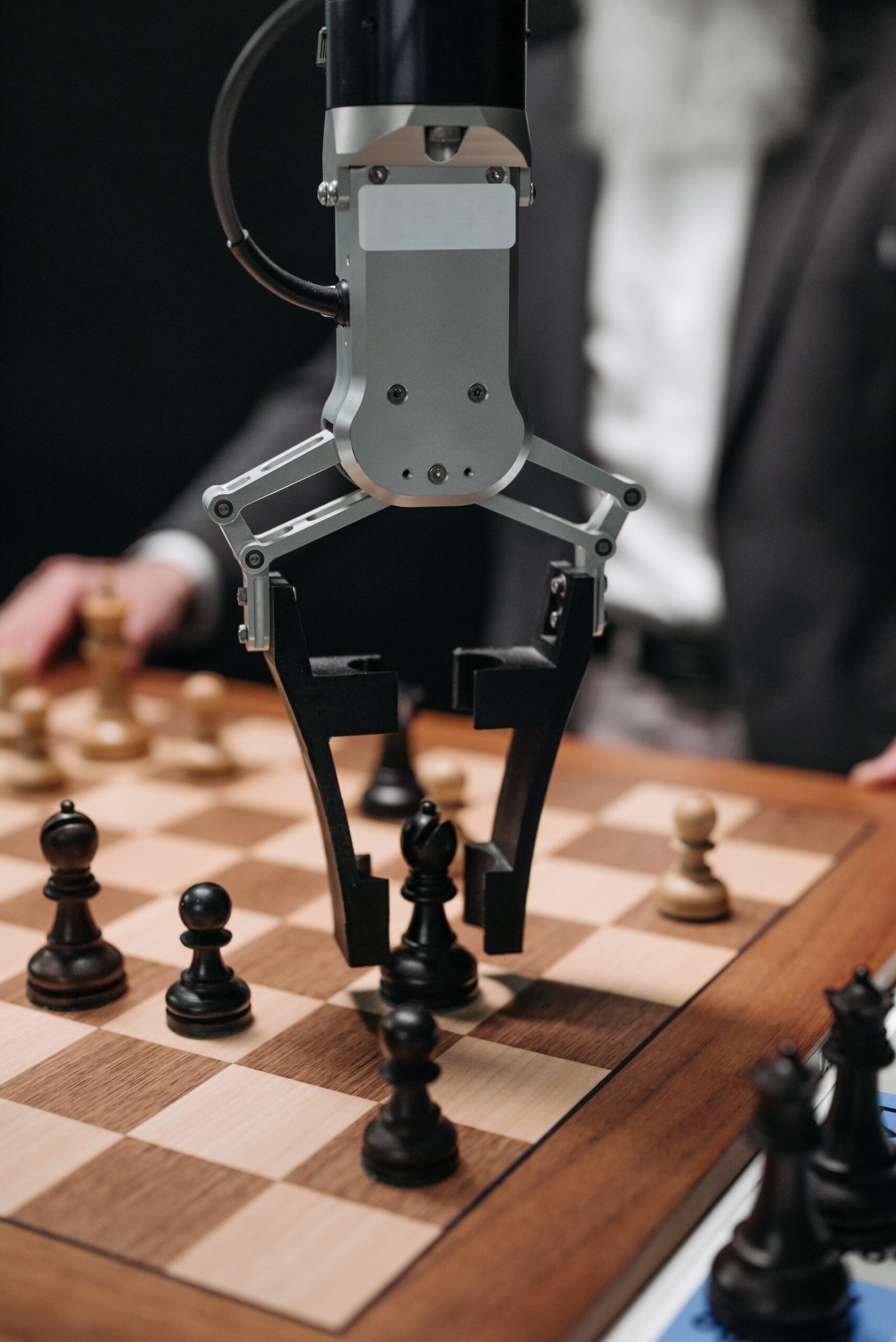 A futuristic AI robot arm making a chess move against a human opponent.