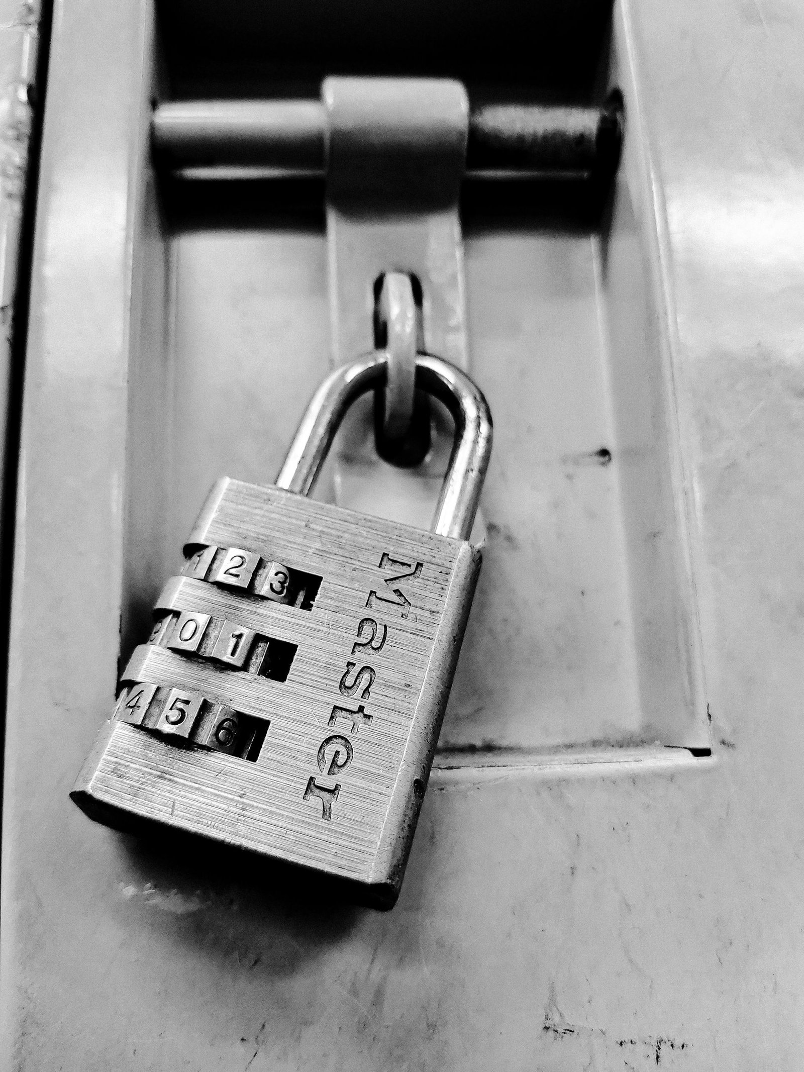 Close-up of a padlock with a combination code dial, representing encryption keys.